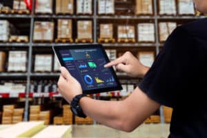 Smart warehouse management system.Worker hands holding tablet on